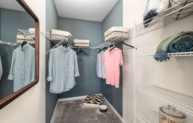 a walk in closet with ample storage