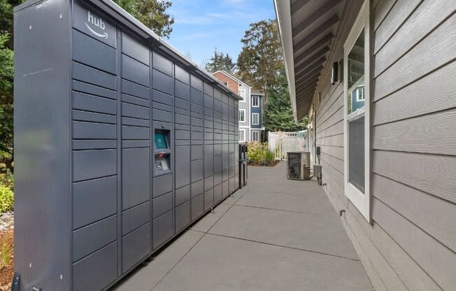 the side of a building with a storage unit on the sidewalk