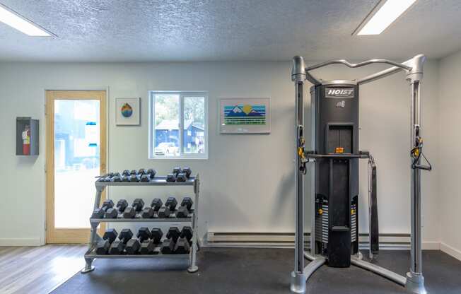 a fitness room with a treadmill and weights