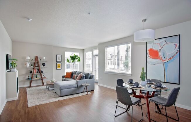 a living room with a couch and a table with chairs