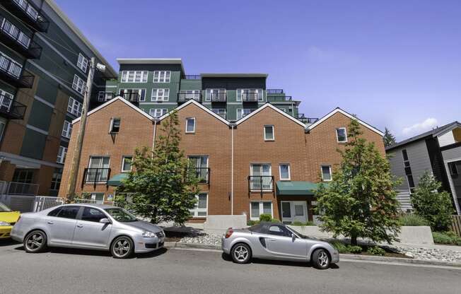 a view from the street of the property building with a green awning and trees at Sedona Apartments, Washington