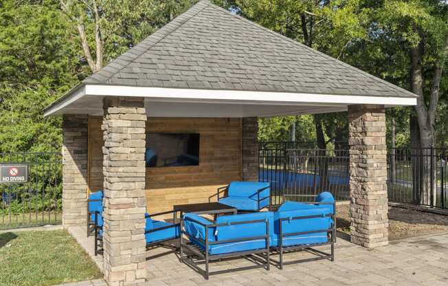 a pavilion with a table and chairs in front of a pool at Trails at Short Pump Apartments, Richmond, VA, 23233