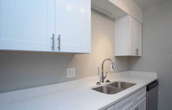 Elevate your lifestyle at Richmond Hills Apartments, where modern kitchens feature sleek white cabinetry and elegant countertops. Enjoy a space designed for comfort and style. Schedule a tour today and see your future home!