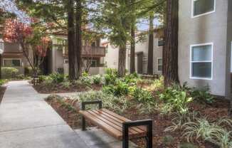 a wooden bench sitting in front of a building at Valley Plaza Villages, Pleasanton, 94566