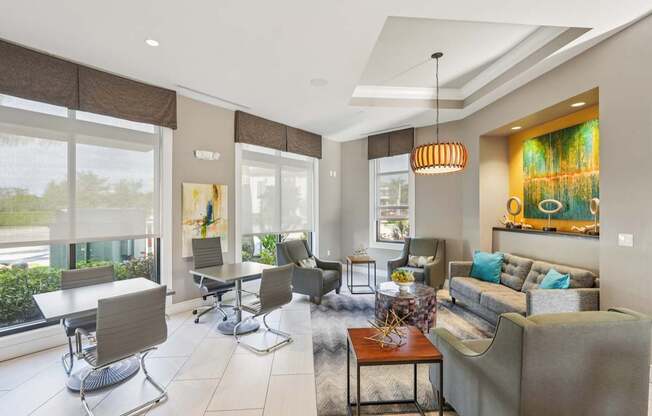 A living room with a grey couch and a brown table.