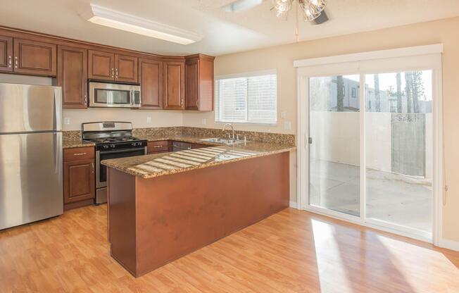 a modern kitchen with stainless steel appliances and wooden cabinets