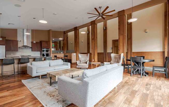 A living room with a grey couch and a wooden floor.