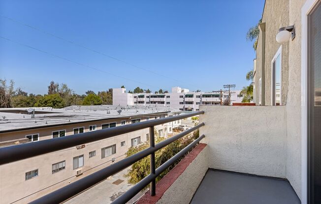 a balcony or terrace with a view of a train