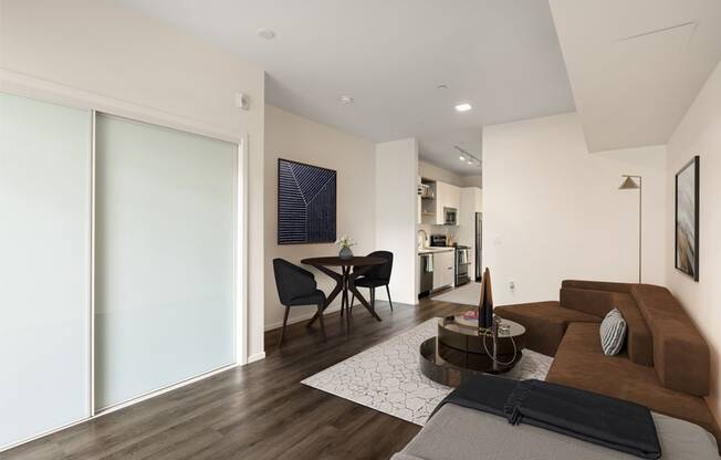 A modern living room with a brown couch and a coffee table.