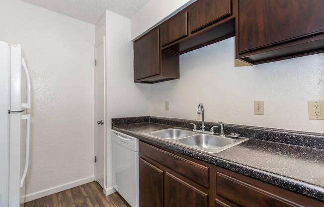 a kitchen with a sink and a mirror