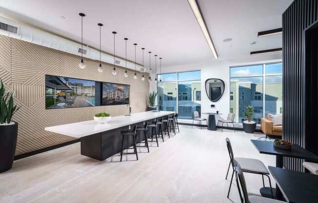 a dining room with a long table and chairs and a large window at NoMa Apartments, Walnut Creek, CA