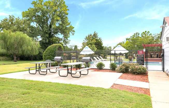 A park with a picnic table and a playground.