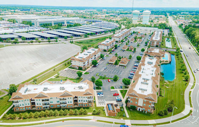an aerial view of a city with buildings and a parking lot