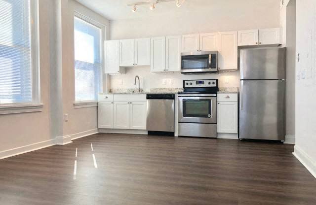 a kitchen with stainless steel appliances and white cabinets