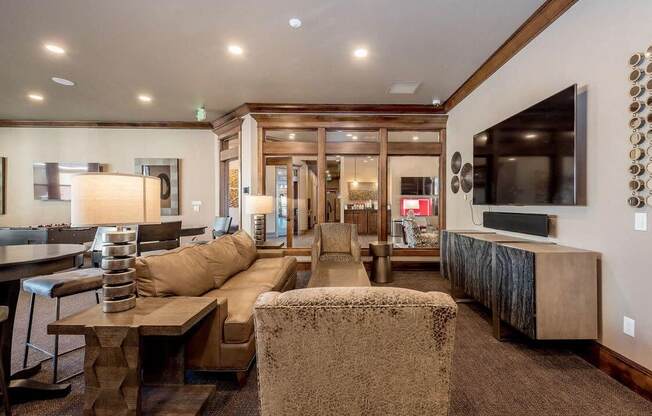 Clubhouse filled with furniture and a flat screen tv