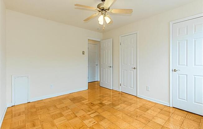 vacant bedroom with hardwood flooring and ceiling fan at chillum place apartments in lamond riggs washington dc