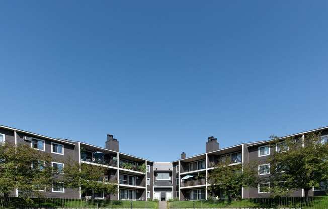 a large apartment building with trees in front of it