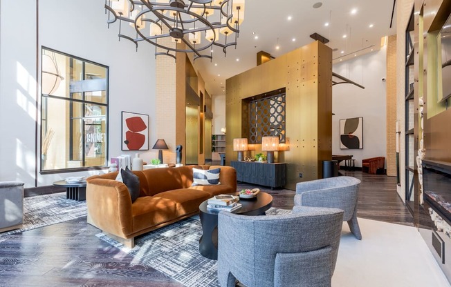 A living room with a brown couch, grey armchair, and a coffee table.