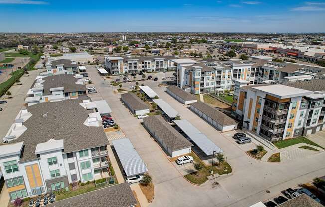 an aerial view of an urban neighbourhood with houses and cars