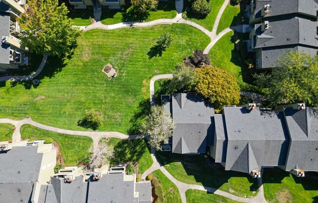 an aerial view of a neighborhood with houses and green grass