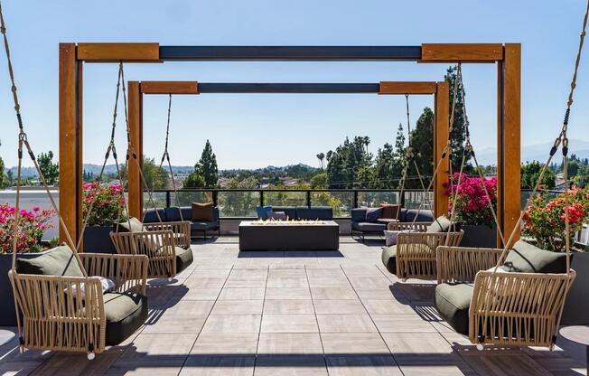 Elevate your relaxation at Modera Pomona with our rooftop deck featuring a cozy firepit and charming swings. Perfect for unwinding with friends, enjoying a sunset, or cozying up by the fire.