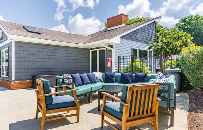 a patio with a table and chairs and a house