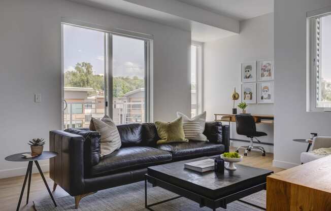 Living room with leather sofa and nook for work space desk at Harvest, Salt Lake City, Utah