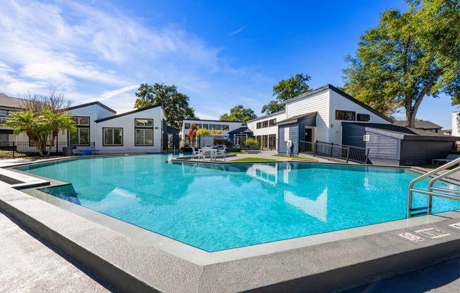 a swimming pool with houses in the background
