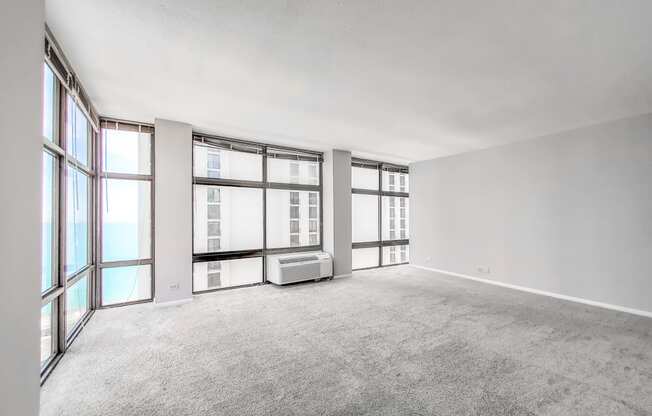 a bedroom with a large window and white walls