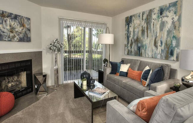 Pet-Friendly Apartments in Richmond CA - Bella Vista At Hilltop - Living Room With Plush Carpeting And An Interior Fireplace