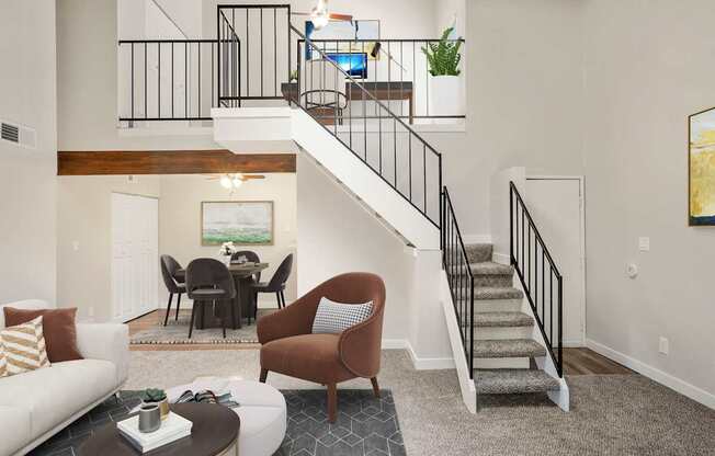 A living room with a staircase leading to the upper floor.