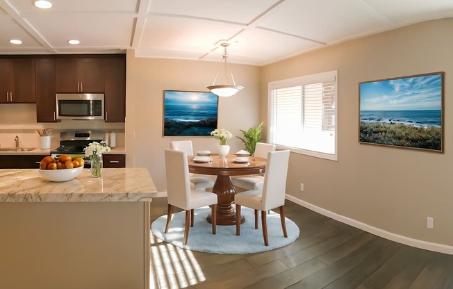 A modern kitchen with a dining table and chairs.