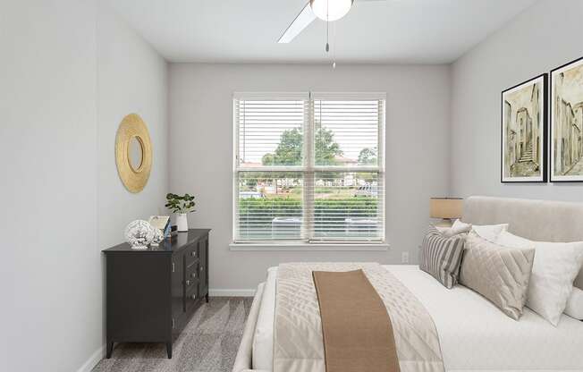 a bedroom with a large window and a ceiling fan Two Addison Place, Pooler GA