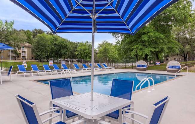 covered table and chairs by pool