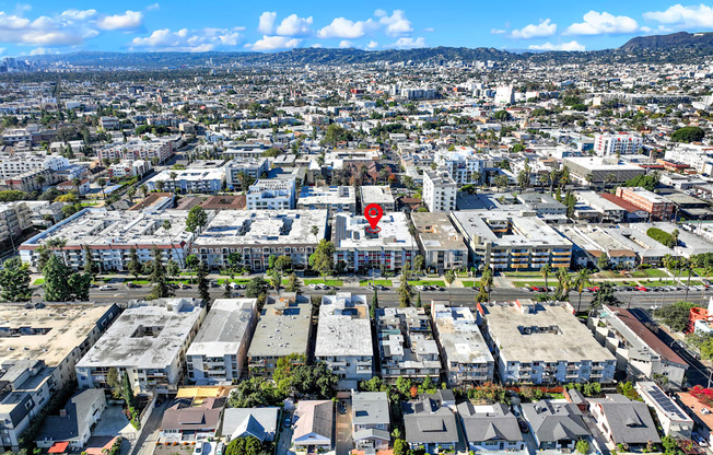 A red pin marks a specific location in a densely populated urban area.