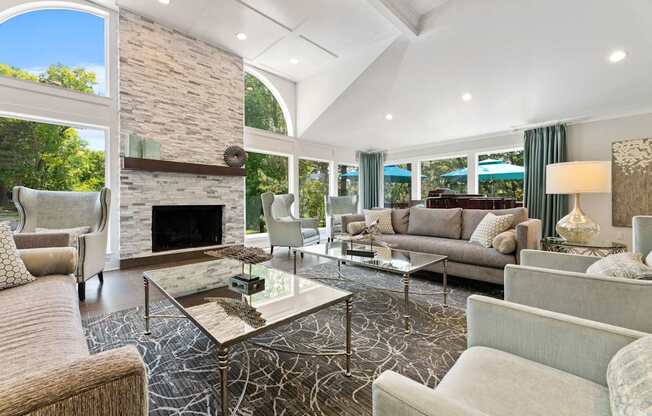 Clubhouse with a stone fireplace and a glass coffee table.