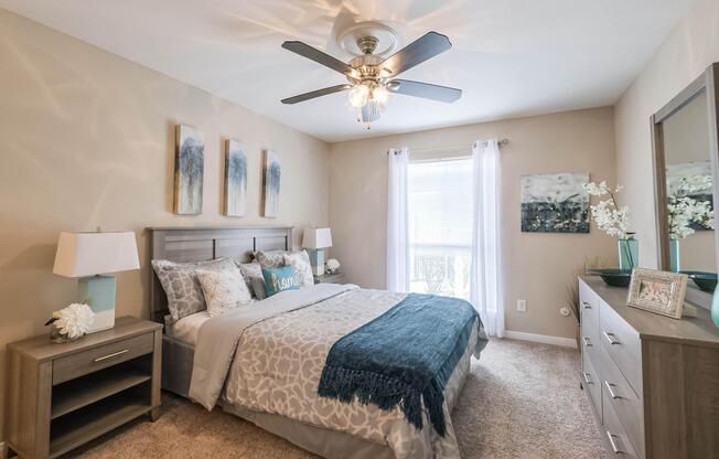 a bedroom with a bed and desk in a room