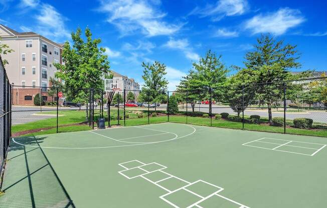 a basketball court at the enclave at city center apartments