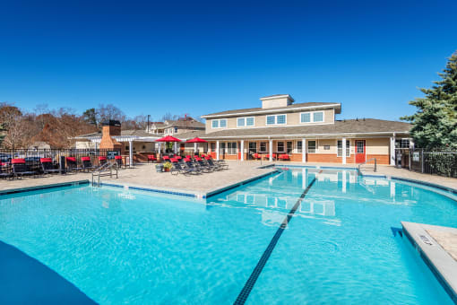 Resort-style swimming pool and outdoor lounge amenities at Village at Broadstone Station apartments in Apex, NC