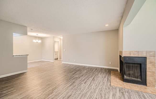 a living room with a fireplace and a wooden floor