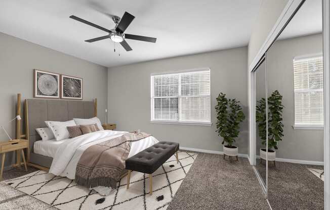 an open bedroom with a large bed and a ceiling fan