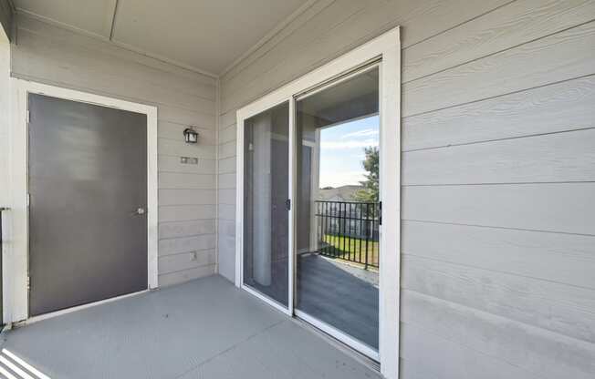 the front door of a house with a balcony