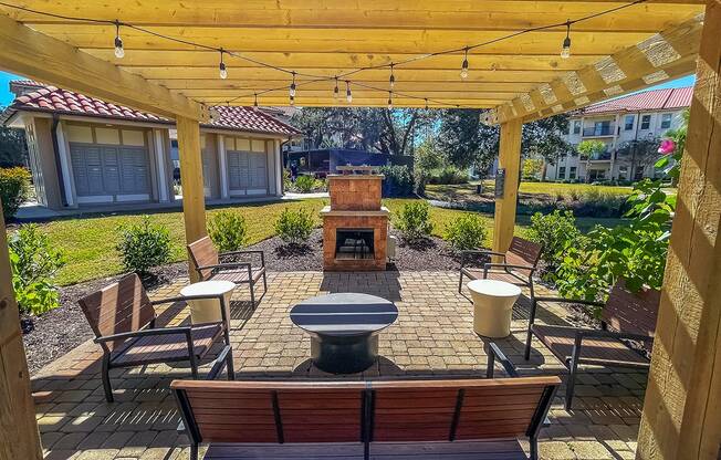 Outdoor fireplace lounge  at Two Addison Place Apartments , Pooler, GA