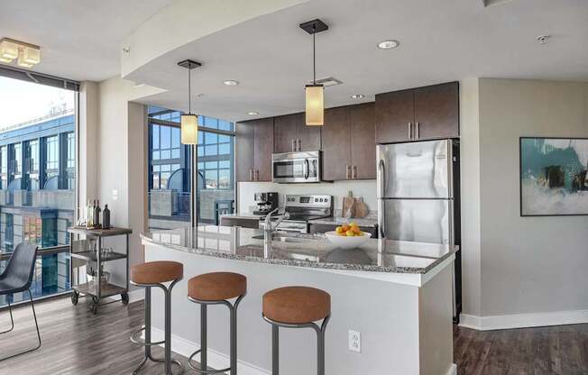 a kitchen with a large island with four stools