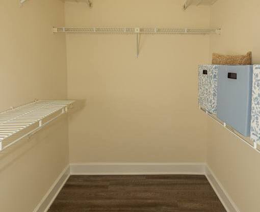 A room with a brown carpet and white walls.