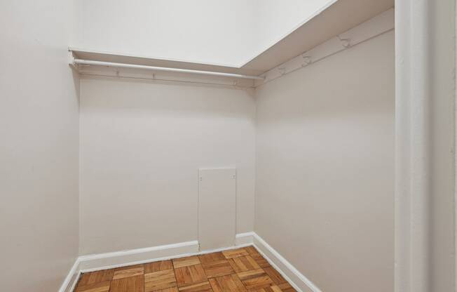 a small room with white walls and a wooden floor