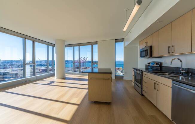 an open kitchen and living room with a view of the city