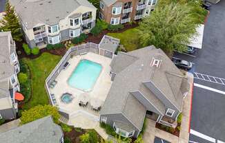 an aerial view of a house with a swimming pool and patio