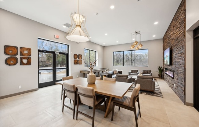 a dining room with a large table and chairs and a living room with couches