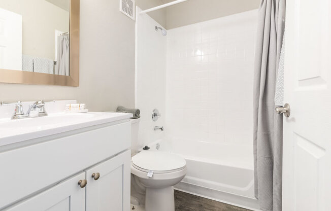 Bathroom with a sink, toilet and bathtub_Rolling Hills Apartments